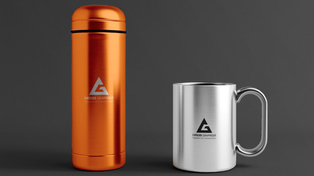 Bouteille isotherme orange en inox et mug en métal argenté gravés avec le logo de l'entreprise.